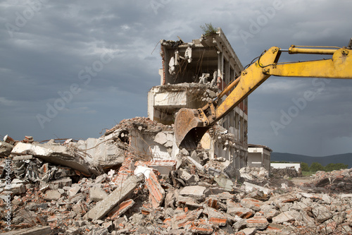 Bulldozer removes the debris from demolition of old buildings