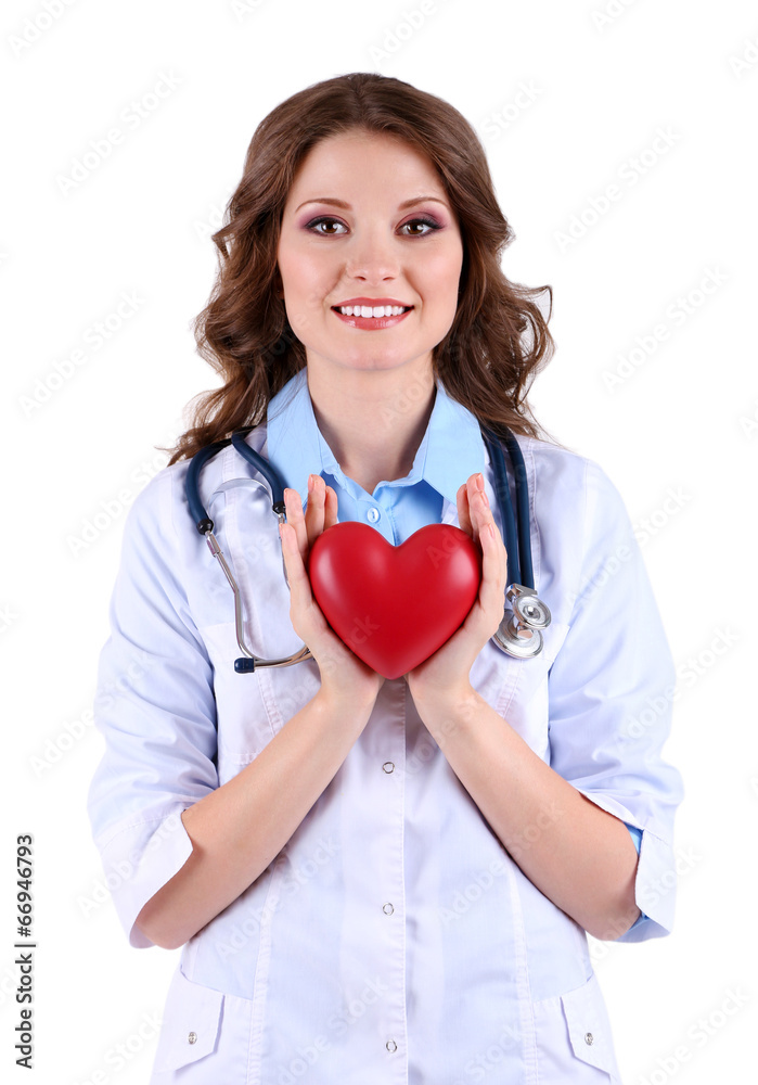 Young beautiful doctor with stethoscope holding heart isolated Young beautiful doctor with stethoscope holding heart isolated