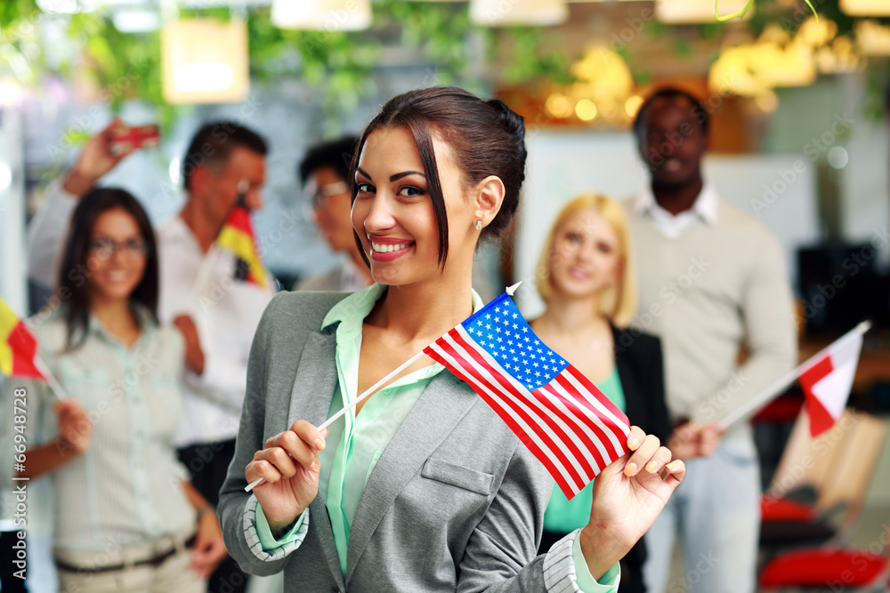 Patriotic businesswoman standing with USA flag 