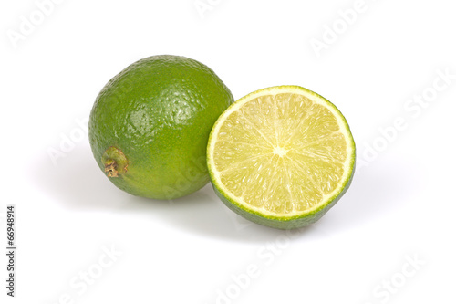 Whole citrus lime and half on the white background.