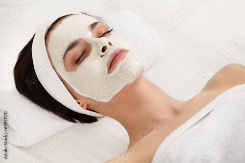 Cosmetic Mask. Beautiful Young Woman Getting a Beauty Treatment