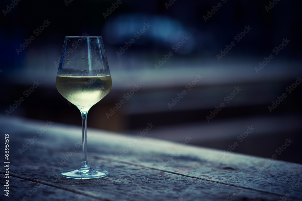 Obraz premium color image of chilled white wine in a glass , with copy space