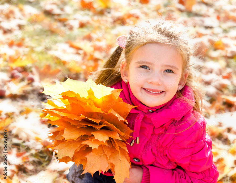 Autumn portrait of cute smiling little girl with maple leaves Autumn portrait of cute smiling little girl with maple leaves