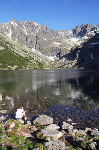 man looking at Black Pond Gasienicowy, Tatra Mountains, Poland