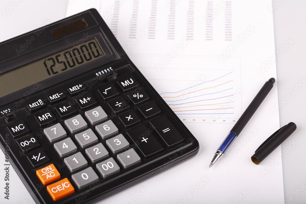Business Charts with calculator and pen Business Charts with calculator and pen