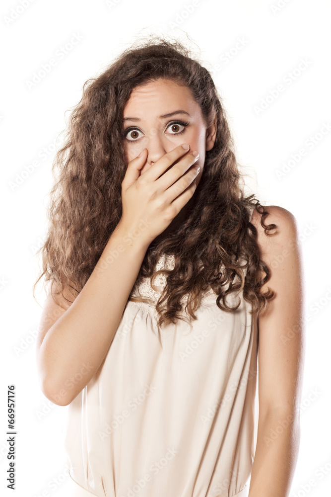 ashamed young girl holding hand on her mouth ashamed young girl holding hand on her mouth