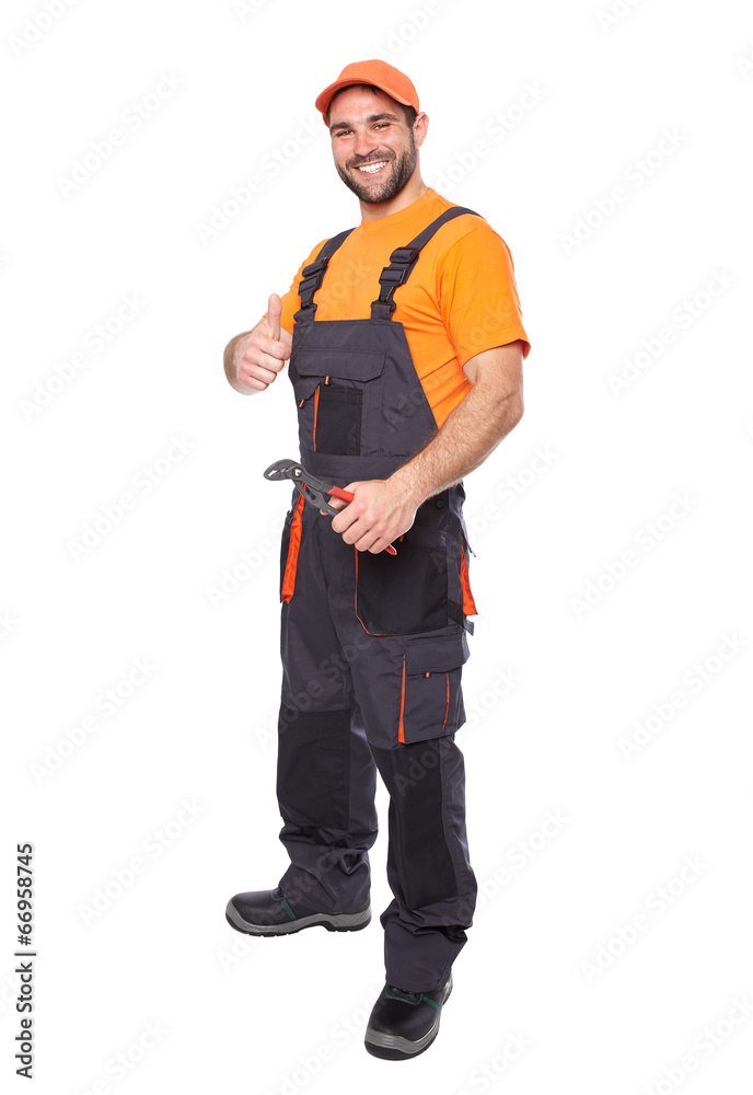 Portrait of a smiling worker in blue uniform holding pliers Portrait of a smiling worker in blue uniform holding pliers