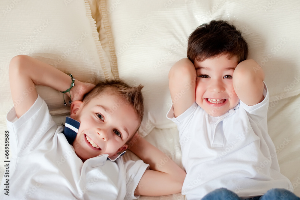 Two boys having fun in bed at home Two boys having fun in bed at home
