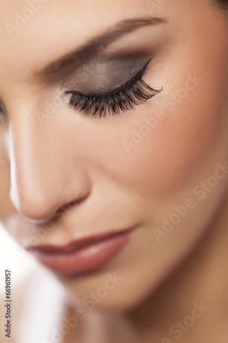 female eye with long false eyelashes