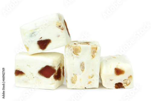 Soft nougat with peanuts and fruits on a white background