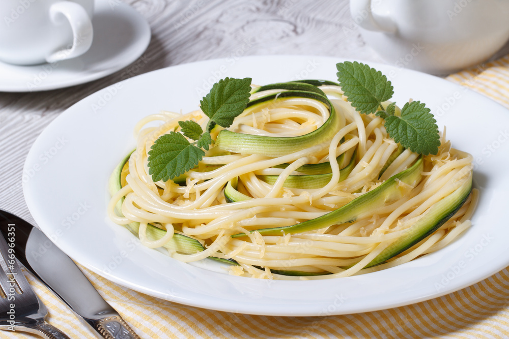 spaghetti pasta with zucchini and cheese on a plate spaghetti pasta with zucchini and cheese on a plate
