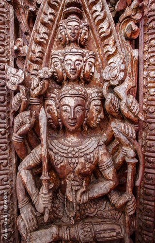 Old wooden door were carved Thai pattern