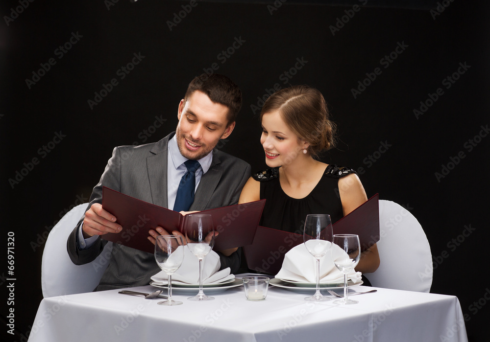 smiling couple with menus at restaurant smiling couple with menus at restaurant