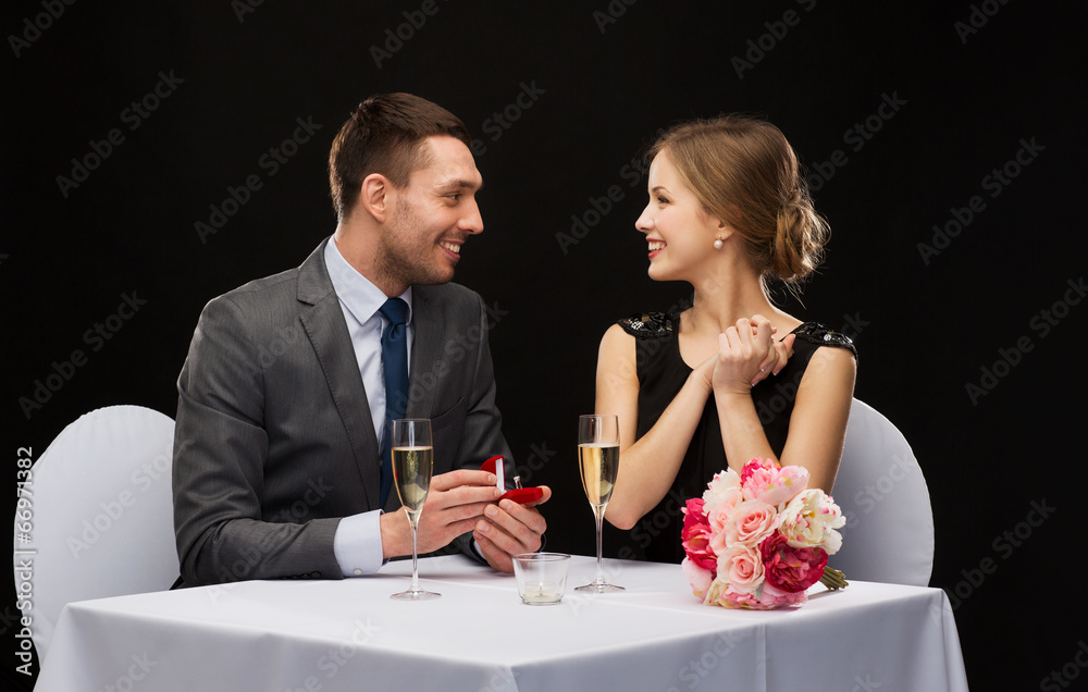 man proposing to his girlfriend at restaurant man proposing to his girlfriend at restaurant