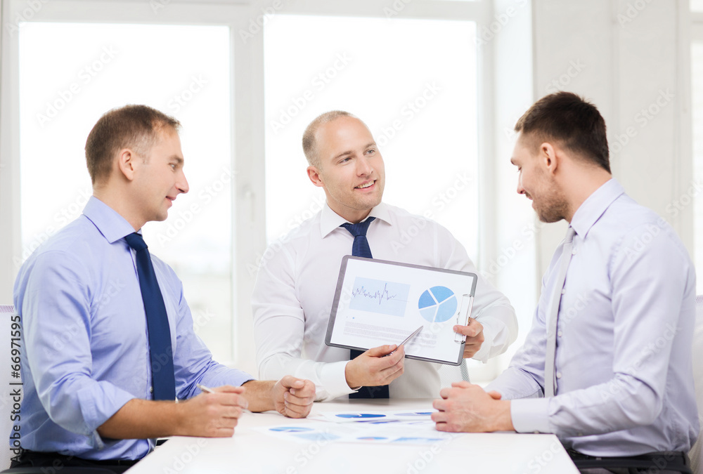 smiling businessmen with papers in office smiling businessmen with papers in office