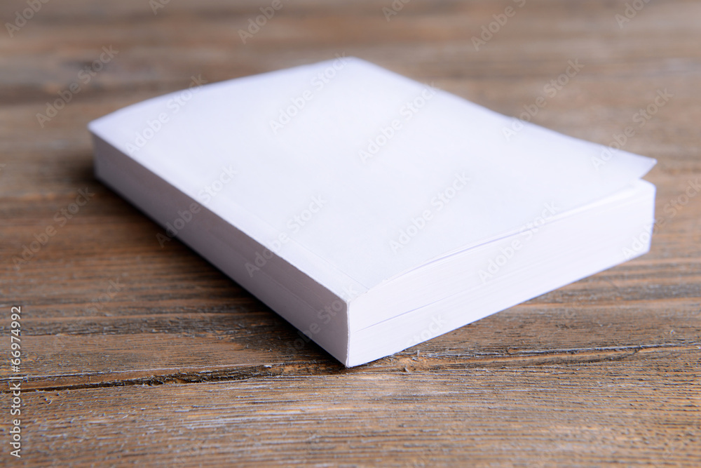 White book on wooden table, close-up White book on wooden table, close-up