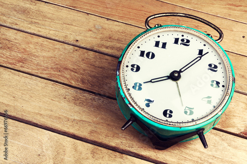 Retro alarm clock on wooden table