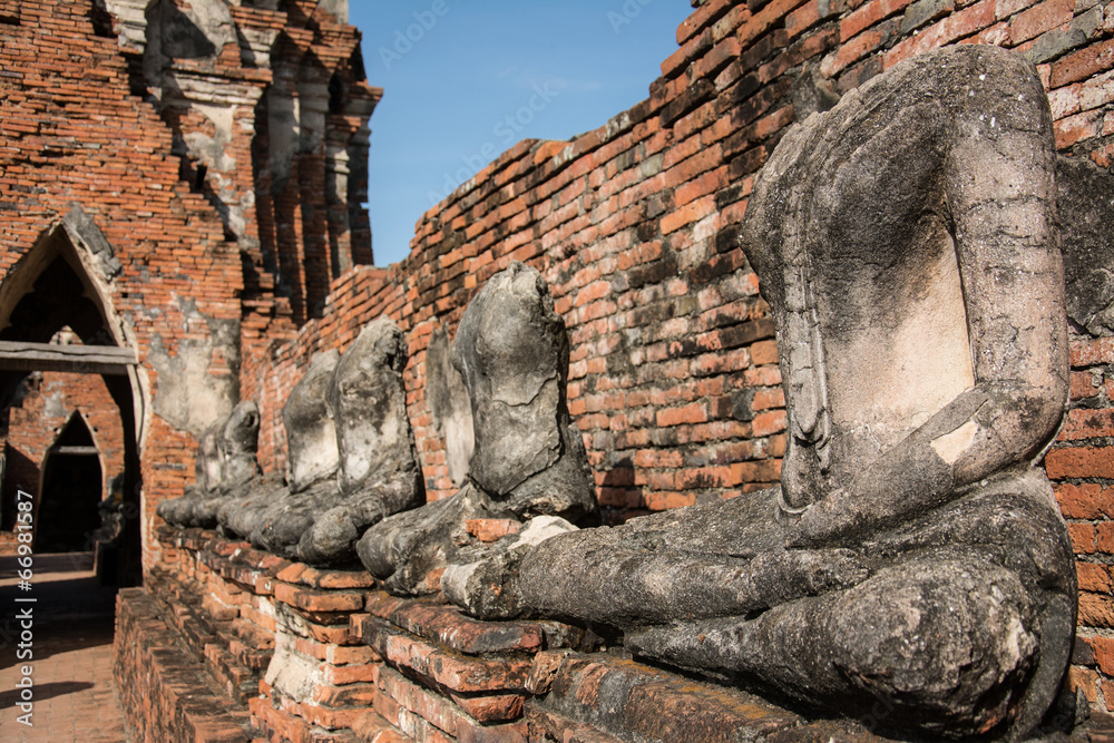 Fototapeta premium row of ruin buddha statue in wat chai wattanaram, ayutthaya, tha