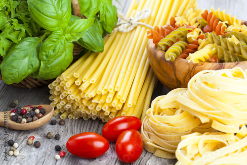 Italian pasta, spaghetti, fettuccine nest with garlic, tomatoes