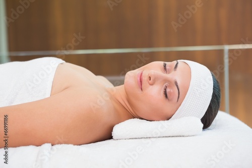 Peaceful brunette lying on massage table