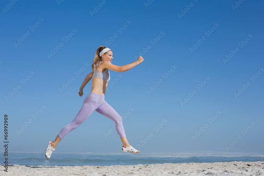 Sporty blonde leaping on the beach Sporty blonde leaping on the beach