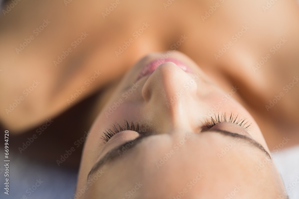 Smiling brunette lying on a towel Smiling brunette lying on a towel