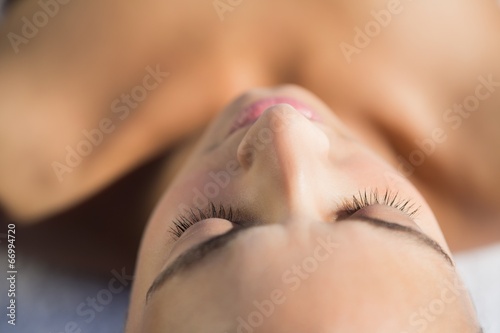 Smiling brunette lying on a towel