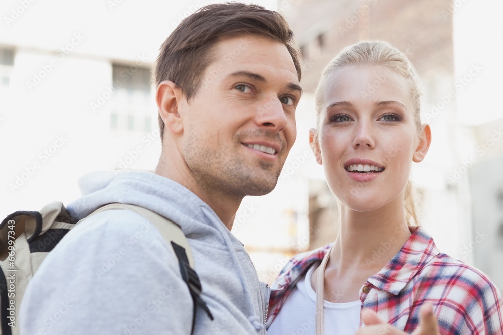 Young tourist couple smiling at something Young tourist couple smiling at something