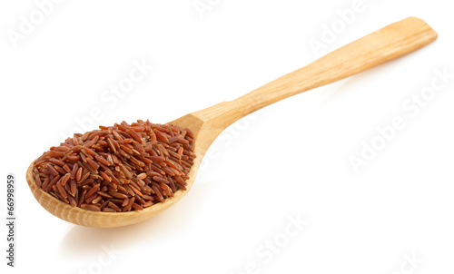 rice in wooden spoon on white