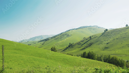Beautiful summer landscape with green hills and bright blue sky