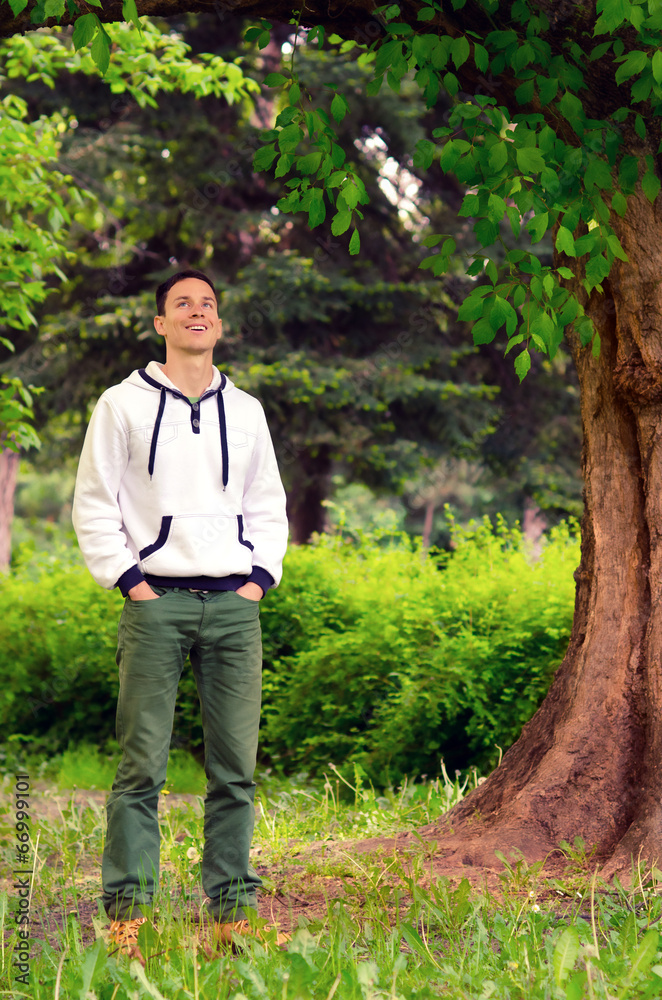 Fototapeta premium Handsome smiling man in the forest