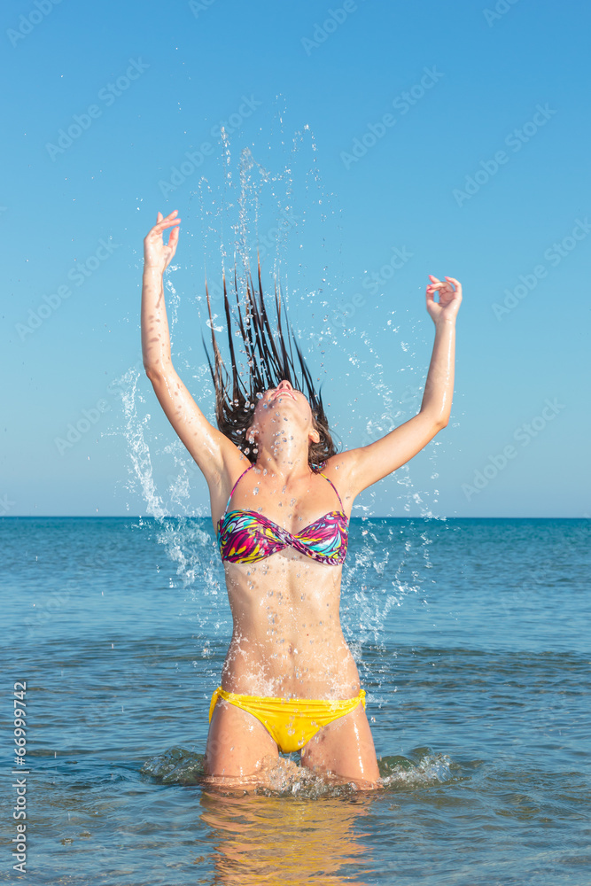 Beauty Model Girl Splashing Water in the ocean