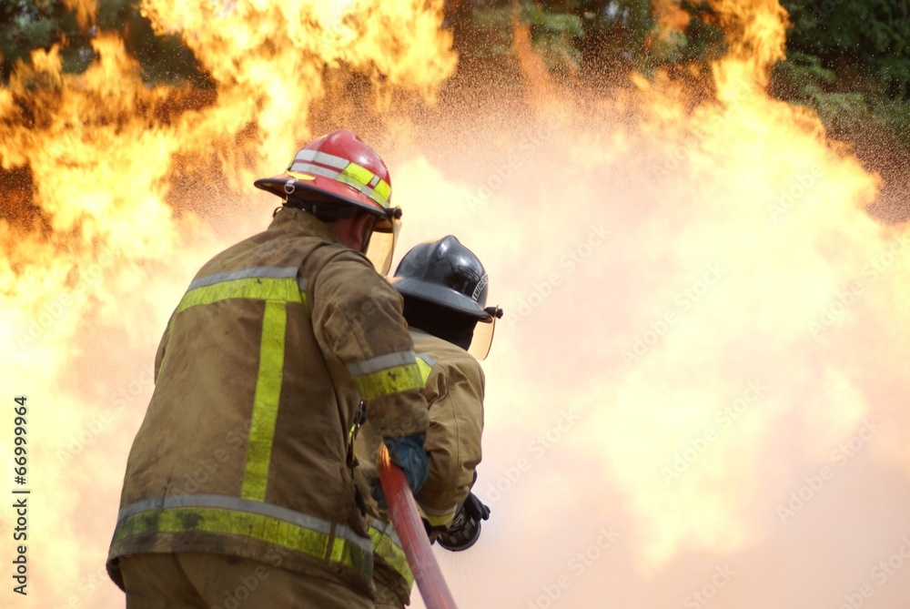 Fototapeta premium fire fighters fighting large blaze