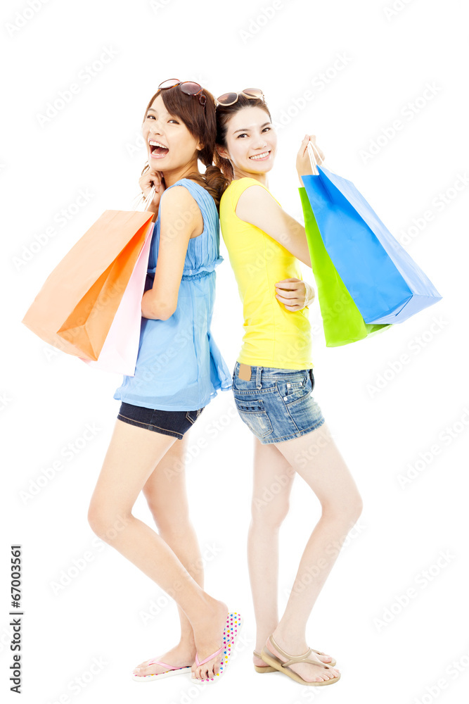 happy and smiling young women with shopping bags happy and smiling young women with shopping bags
