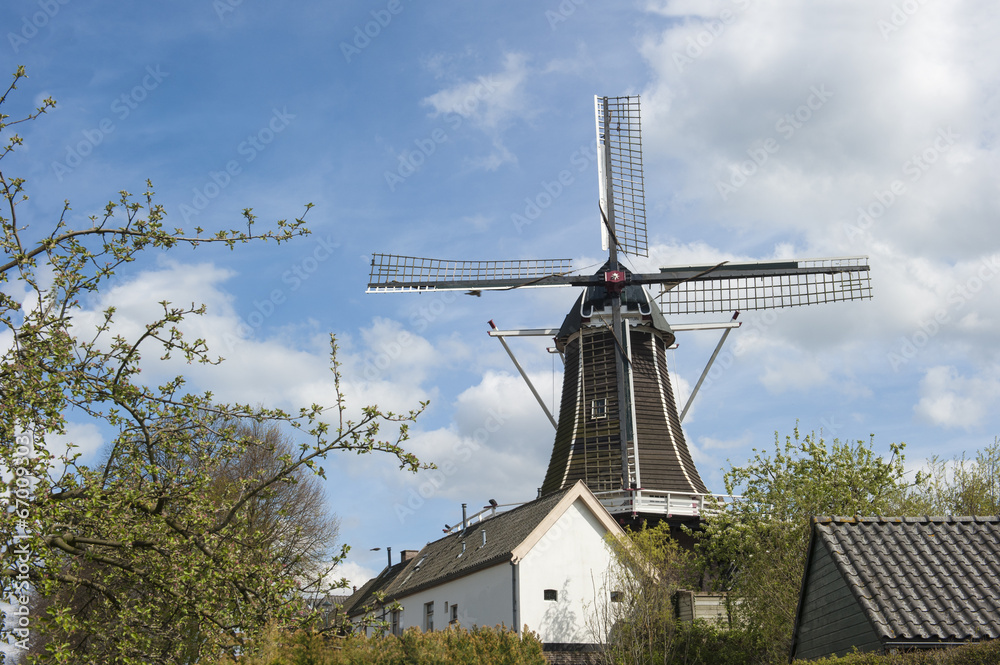 Wooden wind mill in urban setting