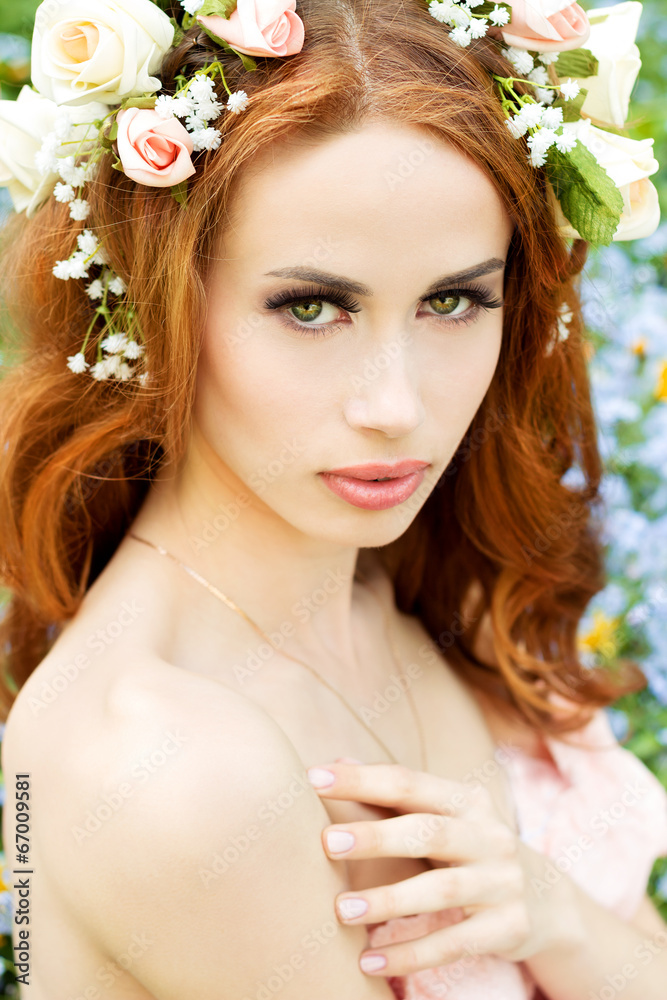 sexy beautiful girl of flowering with flowers in red hair