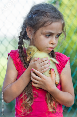 Little girl with gosling