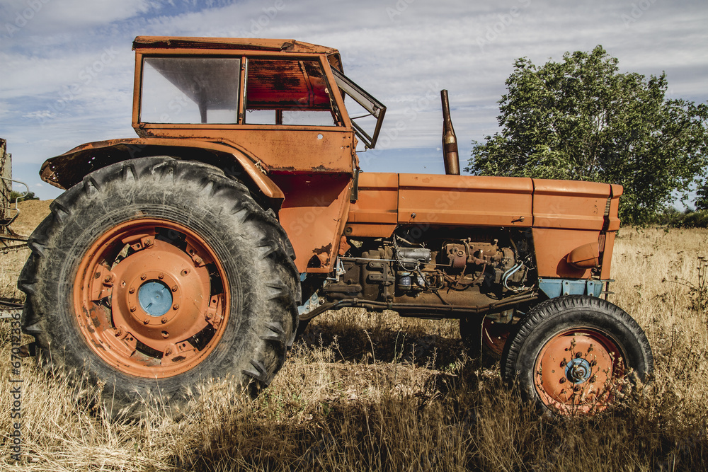 old agricultural tractor abandoned in a farm field old agricultural tractor abandoned in a farm field