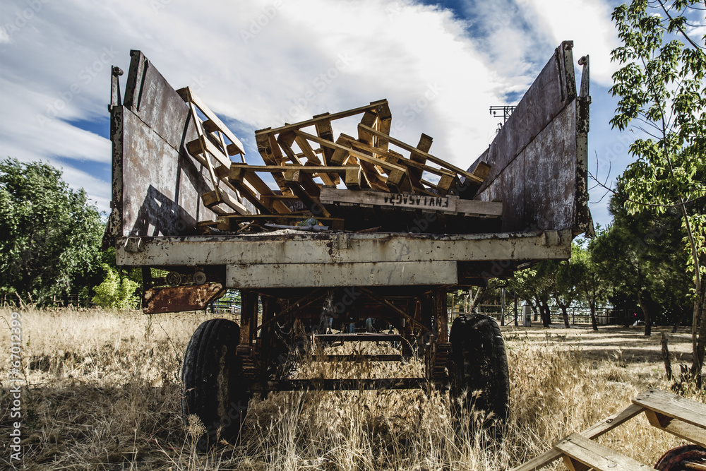 Fototapeta premium machinery, old agricultural tractor abandoned in a farm field