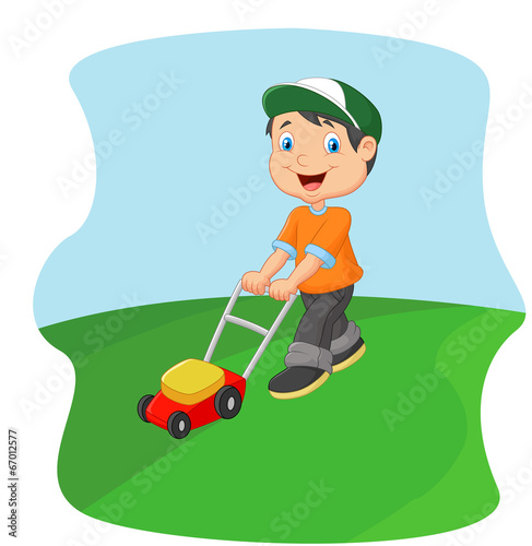 Young man cutting grass with a push lawn mower
