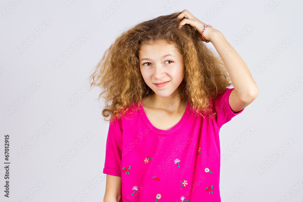 Confused little girl scratching her head Confused little girl scratching her head