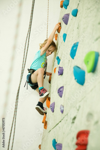 girl climbing up the wall
