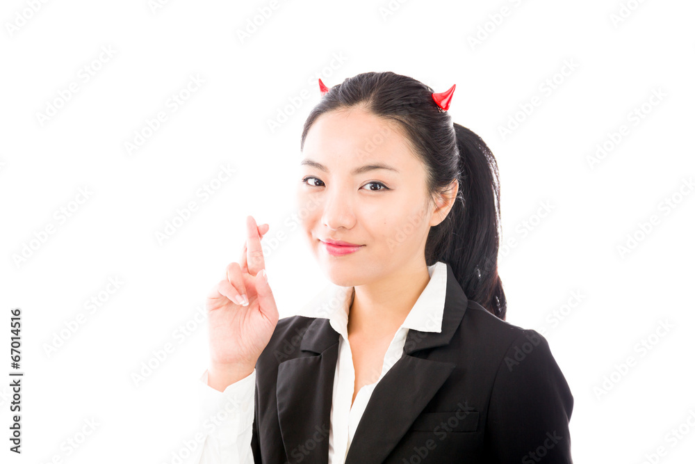 Devil side of a young Asian businesswoman standing with her Devil side of a young Asian businesswoman standing with her