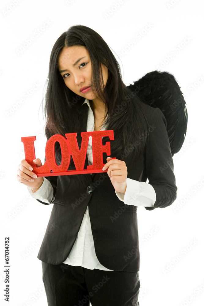 Disappointed Asian young businesswoman dressed up as black angel Disappointed Asian young businesswoman dressed up as black angel