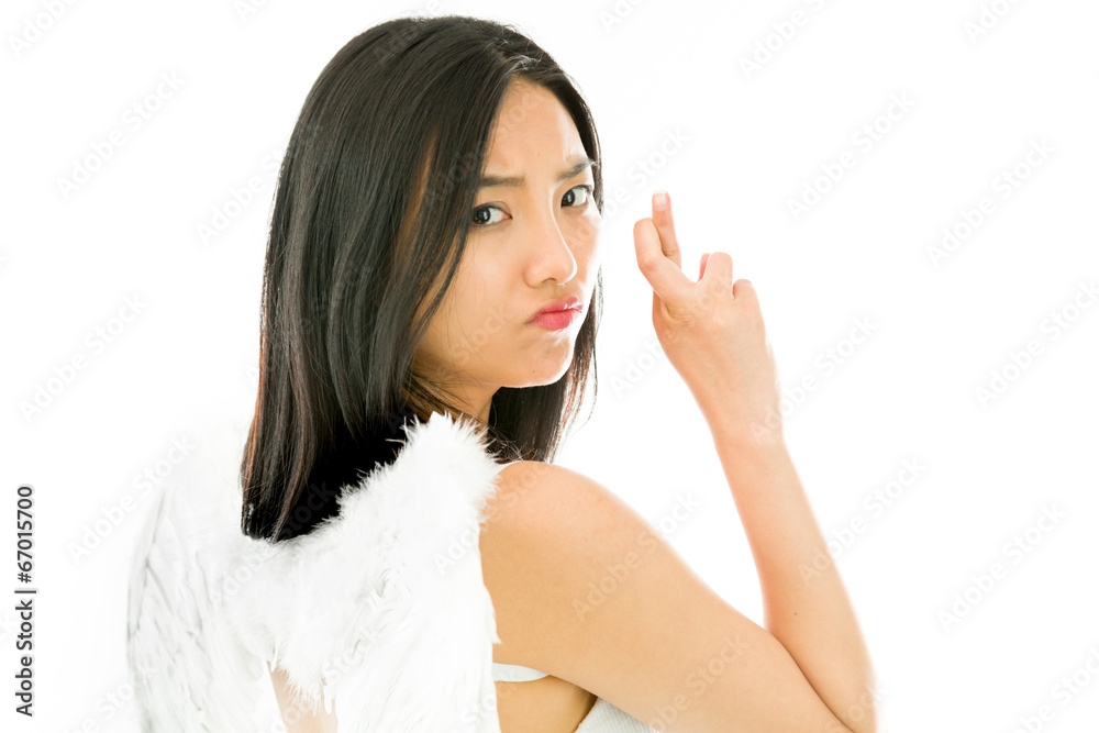 Angel side of a young Asian woman turning back and making her Angel side of a young Asian woman turning back and making her