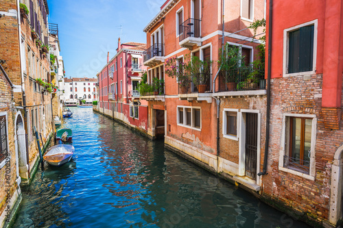 Narrow canal among old colorful brick houses in Venice © Oleg Zhukov