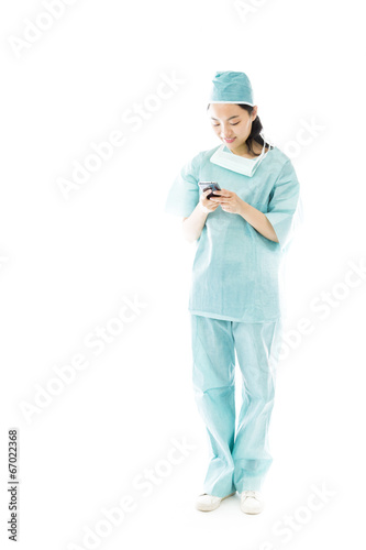 Asian female surgeon text messaging on a mobile phone © bruno135_406