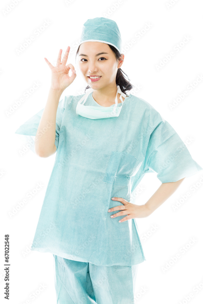 Asian female surgeon showing ok sign isolated on white Asian female surgeon showing ok sign isolated on white