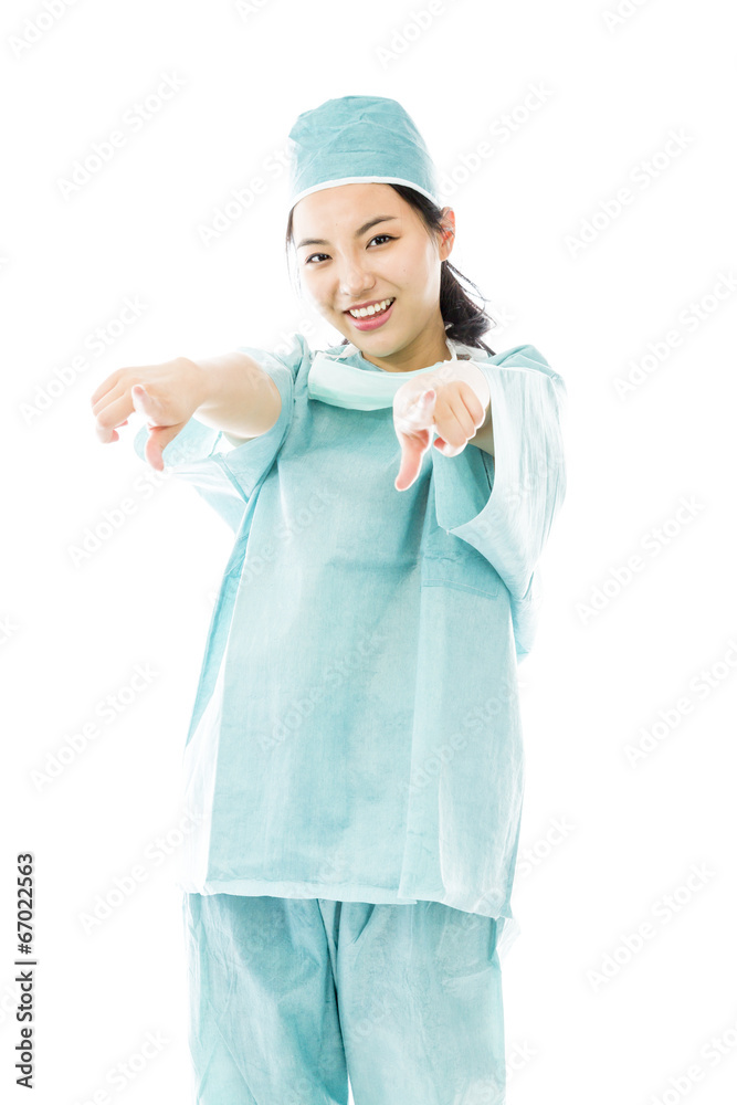 Asian female surgeon pointing at you from both hands isolated on Asian female surgeon pointing at you from both hands isolated on