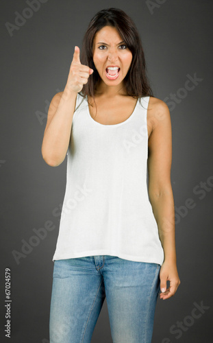 Angry and irratated young woman scolding to somebody photo